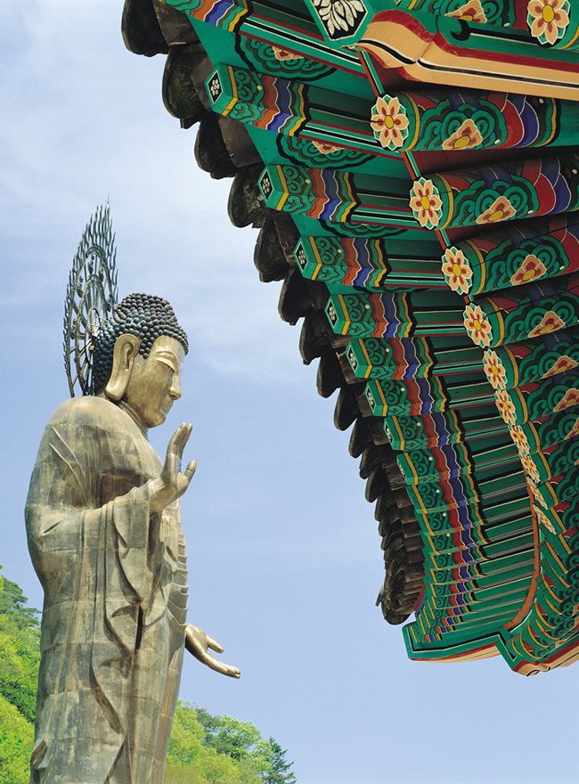 Dancheong roof and standing Buddha statue at Korean Temple